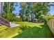 Lush, well-maintained backyard featuring manicured lawn, stepping stones, beautiful landscaping, and mature trees at 1270 Briarwood Ne Rd, Atlanta, GA 30319
