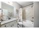 Bathroom with a white vanity, granite countertop, shower-tub combination, and decorative fixtures at 1270 Briarwood Ne Rd, Atlanta, GA 30319