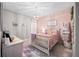 Charming bedroom with a cozy bed, soft pink accents, and delightful decor at 1270 Briarwood Ne Rd, Atlanta, GA 30319
