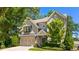 Charming two-story home with a well-manicured lawn, two-car garage, neutral siding, and black shutters at 1270 Briarwood Ne Rd, Atlanta, GA 30319