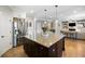 Open concept kitchen with dark island, granite countertop, flowing into adjacent living room at 1270 Briarwood Ne Rd, Atlanta, GA 30319