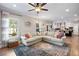 Open-concept living room with hardwood floors, large sofa, and easy access to kitchen at 1270 Briarwood Ne Rd, Atlanta, GA 30319