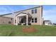 Large backyard with green grass and brick home featuring a covered patio at 209 Chiswick Loop, Stockbridge, GA 30281
