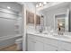 Well-lit bathroom with double sink vanity, tiled floors, and a shower/tub combo at 209 Chiswick Loop, Stockbridge, GA 30281