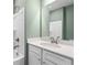 Clean bathroom featuring a white vanity, framed mirror, and shower-tub combo at 209 Chiswick Loop, Stockbridge, GA 30281