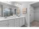 Bright bathroom featuring double sinks, a large mirror, and updated fixtures at 209 Chiswick Loop, Stockbridge, GA 30281