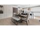 Elegant dining room with modern furniture, hardwood floors, and kitchen access at 209 Chiswick Loop, Stockbridge, GA 30281