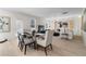 Dining area with contemporary table set, natural light, and open layout to the living space at 209 Chiswick Loop, Stockbridge, GA 30281