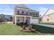 Beautiful two-story brick home with a manicured front yard and attached two-car garage at 209 Chiswick Loop, Stockbridge, GA 30281