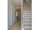 Bright hallway with hardwood floors and a staircase leading to the upper level at 209 Chiswick Loop, Stockbridge, GA 30281