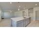 Open kitchen with a large island, stainless steel appliances, and hardwood floors at 209 Chiswick Loop, Stockbridge, GA 30281