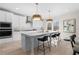 Bright kitchen with white cabinets, a large center island, and modern stainless steel appliances at 209 Chiswick Loop, Stockbridge, GA 30281