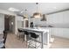 Spacious kitchen featuring a large island, modern lighting, and white cabinets at 209 Chiswick Loop, Stockbridge, GA 30281