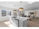 Open concept kitchen with a large island, stainless steel appliances, and hardwood floors at 209 Chiswick Loop, Stockbridge, GA 30281