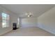 Bright living room showcases a modern fireplace and large windows for ample natural light and views at 209 Chiswick Loop, Stockbridge, GA 30281