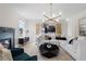 Spacious living room with a fireplace, modern lighting, and comfortable seating arrangement at 209 Chiswick Loop, Stockbridge, GA 30281