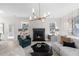 Inviting living room featuring a fireplace, chic decor, and large windows at 209 Chiswick Loop, Stockbridge, GA 30281