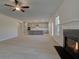 Open concept living space with a view to the kitchen, fireplace, wood-look floors, and recessed lighting at 209 Chiswick Loop, Stockbridge, GA 30281
