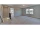 Bright loft with neutral carpet, a staircase, and views from the windows, creating a flexible living space at 209 Chiswick Loop, Stockbridge, GA 30281