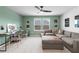 Spacious loft area with green walls, study space, and a comfortable sectional sofa at 209 Chiswick Loop, Stockbridge, GA 30281