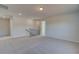 Open loft area with plush carpet, a staircase with dark wooden handrail, and neutral paint at 209 Chiswick Loop, Stockbridge, GA 30281