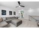 Cozy loft featuring a gray sectional sofa, study area, and views of the stairwell at 209 Chiswick Loop, Stockbridge, GA 30281