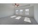 Main bedroom with a tray ceiling, carpet, lots of light, and a ceiling fan for added comfort at 209 Chiswick Loop, Stockbridge, GA 30281