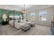 Spacious bedroom with a four-poster bed, stylish decor, and lots of natural light at 209 Chiswick Loop, Stockbridge, GA 30281
