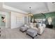 Spacious bedroom with a four-poster bed, stylish decor, and lots of natural light at 209 Chiswick Loop, Stockbridge, GA 30281