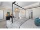 Spacious bedroom with a four-poster bed, sitting area, and modern chandelier at 209 Chiswick Loop, Stockbridge, GA 30281