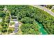 Aerial view revealing the serene lake winding through a densely wooded neighborhood, offering privacy at 3131 Lee Cir, Buford, GA 30518