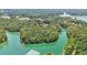 Overhead shot showcases the tranquil waters surrounding wooded islands, promising a peaceful retreat at 3131 Lee Cir, Buford, GA 30518