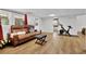 Finished basement with leather sofa, exercise equipment, and ample living space at 3131 Lee Cir, Buford, GA 30518