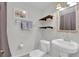 Bright bathroom with vanity, toilet, and decorative shelving at 3131 Lee Cir, Buford, GA 30518