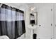 Chic bathroom features pedestal sink, elegant mirror, and shower with stylish curtain at 3131 Lee Cir, Buford, GA 30518