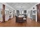 The dining room features hardwood flooring, a wooden dining table and chairs, and stainless appliances in the kitchen at 3131 Lee Cir, Buford, GA 30518
