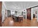 Dining and kitchen area boasts hardwood floors, a gray island, and a sliding barn door at 3131 Lee Cir, Buford, GA 30518
