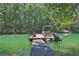Picturesque dock with a small boat on a tranquil lake surrounded by trees at 3131 Lee Cir, Buford, GA 30518