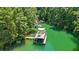 Unique lake structure with a floating platform and covered seating area amidst lush greenery at 3131 Lee Cir, Buford, GA 30518