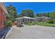 Charming home with a welcoming front porch, well-manicured lawn, and a circular driveway at 3131 Lee Cir, Buford, GA 30518