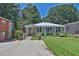 Charming home boasts a well-kept front yard, covered porch, and welcoming curb appeal at 3131 Lee Cir, Buford, GA 30518