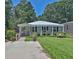 Charming single-story home with a well-manicured lawn, inviting front porch, and a cozy bench at 3131 Lee Cir, Buford, GA 30518