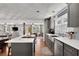 Open kitchen features grey cabinets, stainless steel appliances, and an island with bar seating at 3131 Lee Cir, Buford, GA 30518