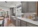 The eat-in kitchen features grey cabinets, stainless appliances, and a quartz countertop at 3131 Lee Cir, Buford, GA 30518