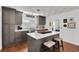 The open kitchen features grey cabinets, a large island with bar seating, and stainless steel appliances at 3131 Lee Cir, Buford, GA 30518