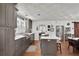 The open kitchen features grey cabinets, a large island with seating, and stainless steel appliances at 3131 Lee Cir, Buford, GA 30518