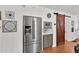 Kitchen boasts stainless steel appliances, stylish grey cabinets, and a modern sliding barn door at 3131 Lee Cir, Buford, GA 30518