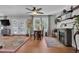 Cozy living room features a ceiling fan, hardwood flooring, fireplace, and French doors to the deck at 3131 Lee Cir, Buford, GA 30518