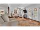 Cozy living room showcases hardwood floors, a neutral color palette, French doors, and a ceiling fan at 3131 Lee Cir, Buford, GA 30518