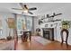 Bright living area with hardwood floors, a charming fireplace, and a small table and chairs at 3131 Lee Cir, Buford, GA 30518
